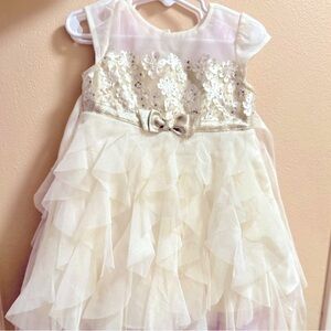 Elegant cream kids dress with delicate gold accent.